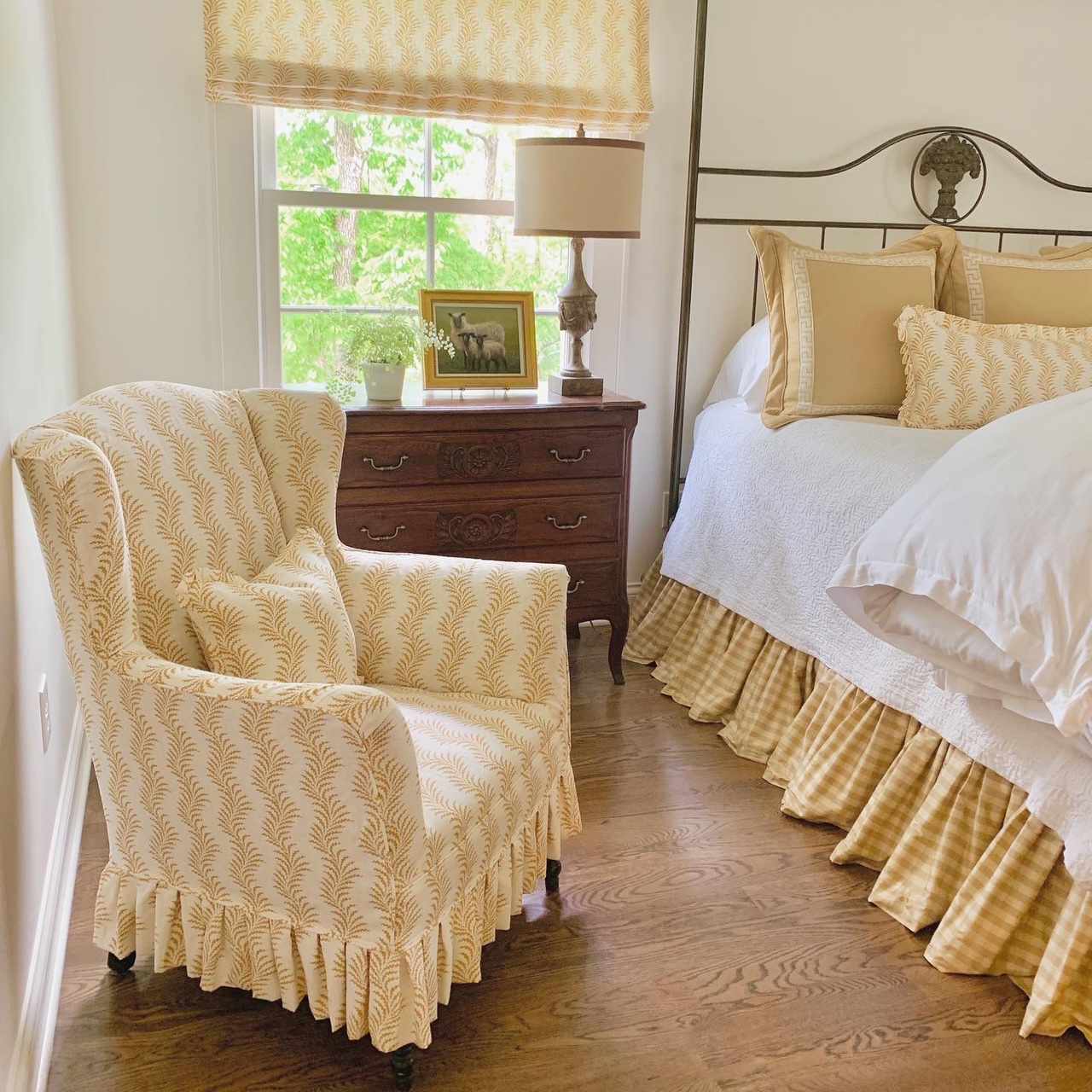 A bedroom adorned with fabrics featuring a yellow and white pattern.