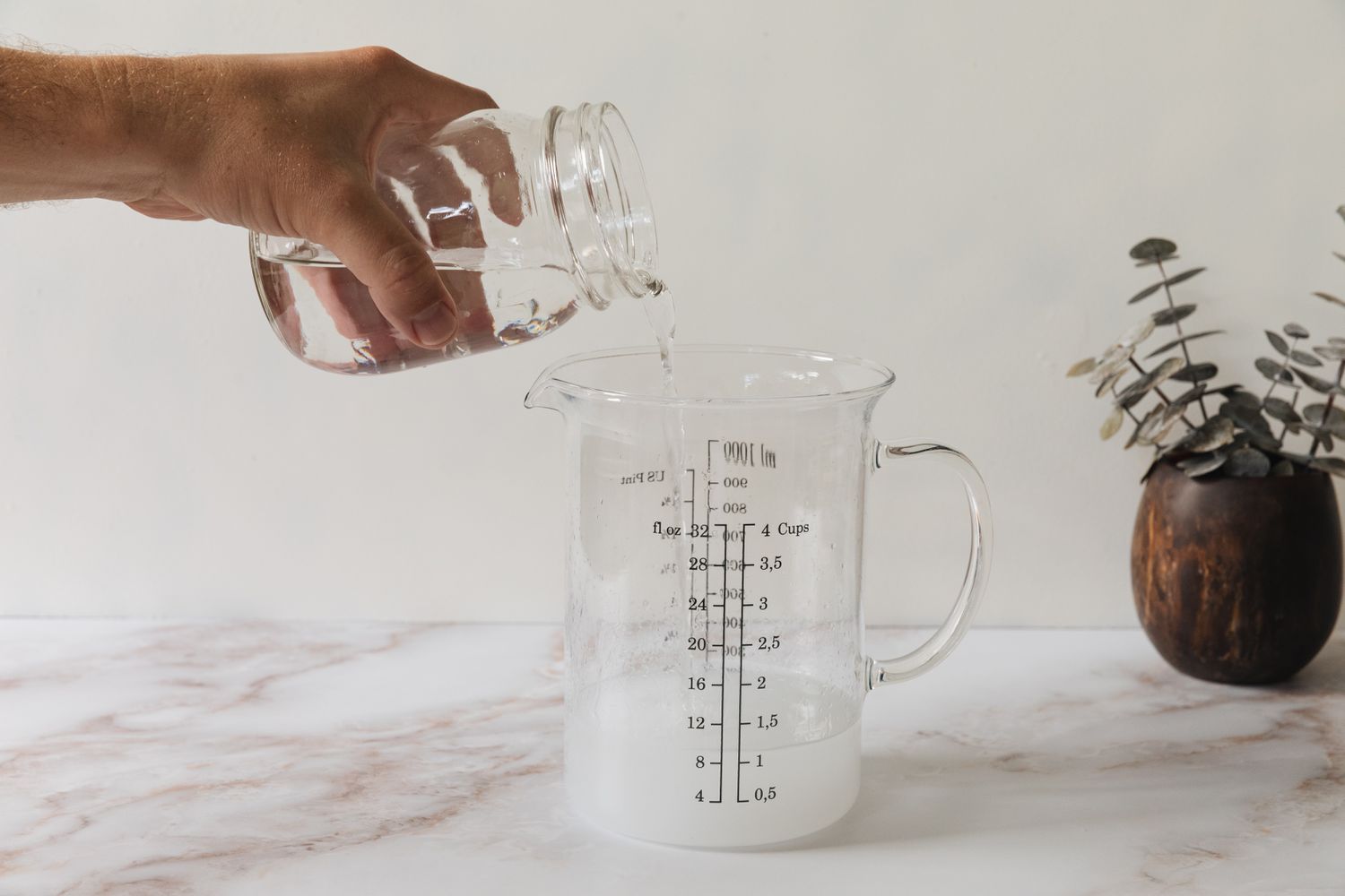 pouring water into the measuring cup