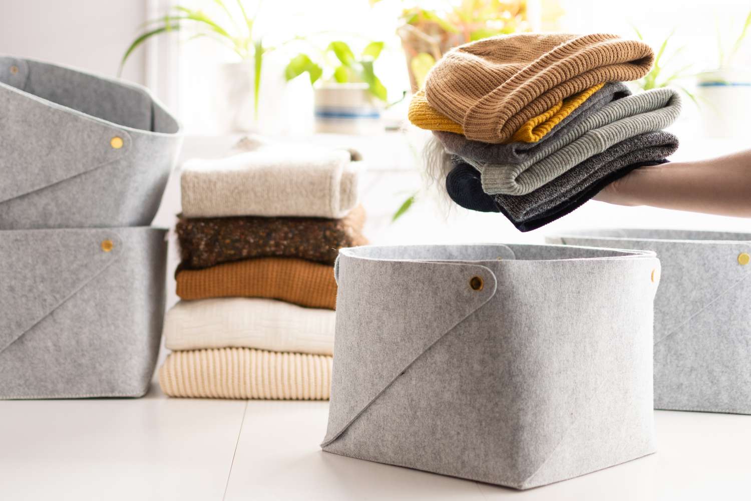 Clothing accessories neatly arranged in gray storage containers.