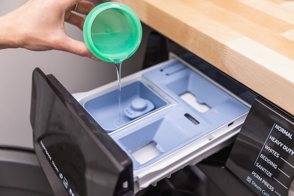 Powerful laundry detergent is added to the washing machine.