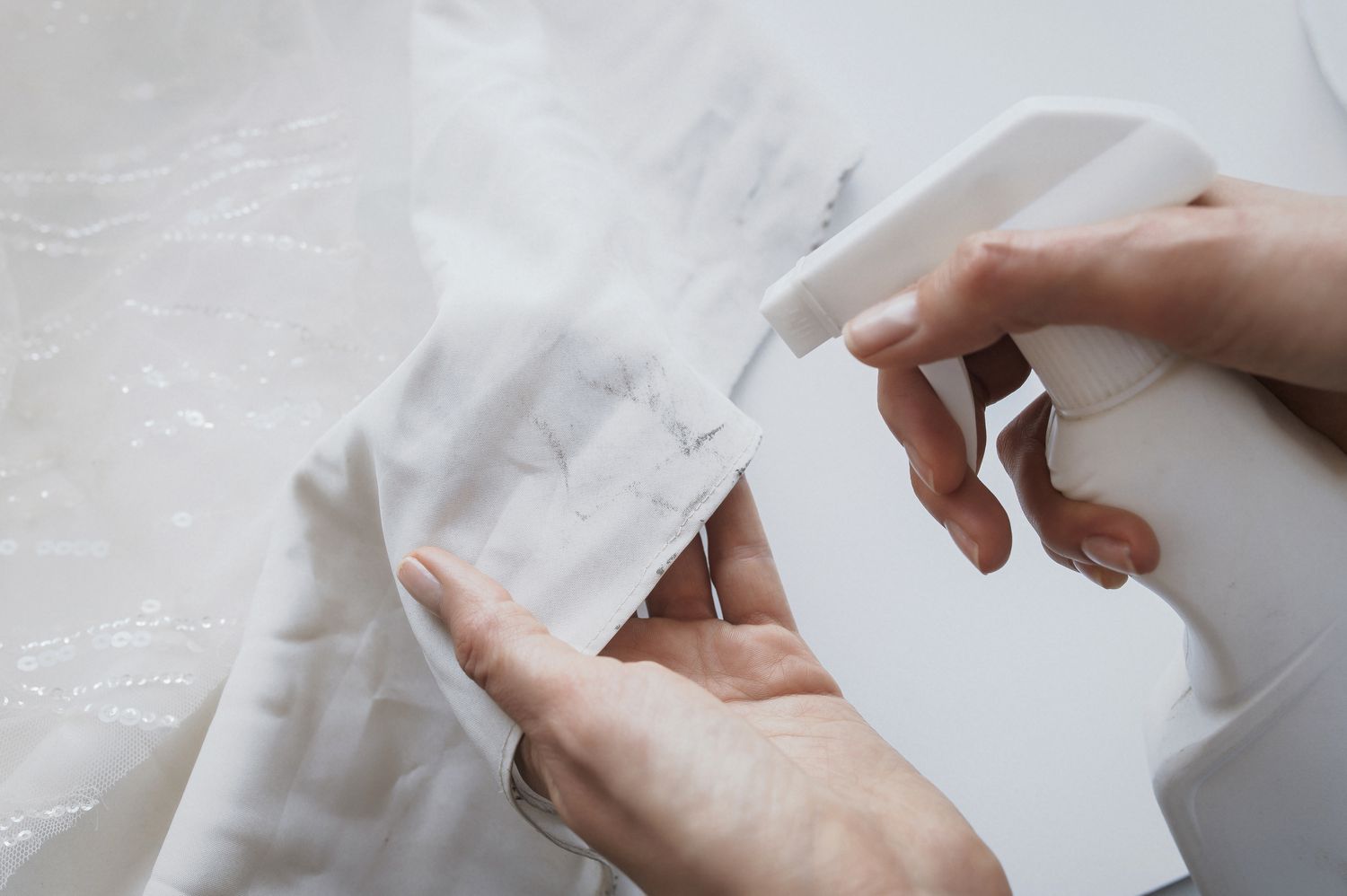 Stain on the wedding gown treated in advance using a spray bottle.